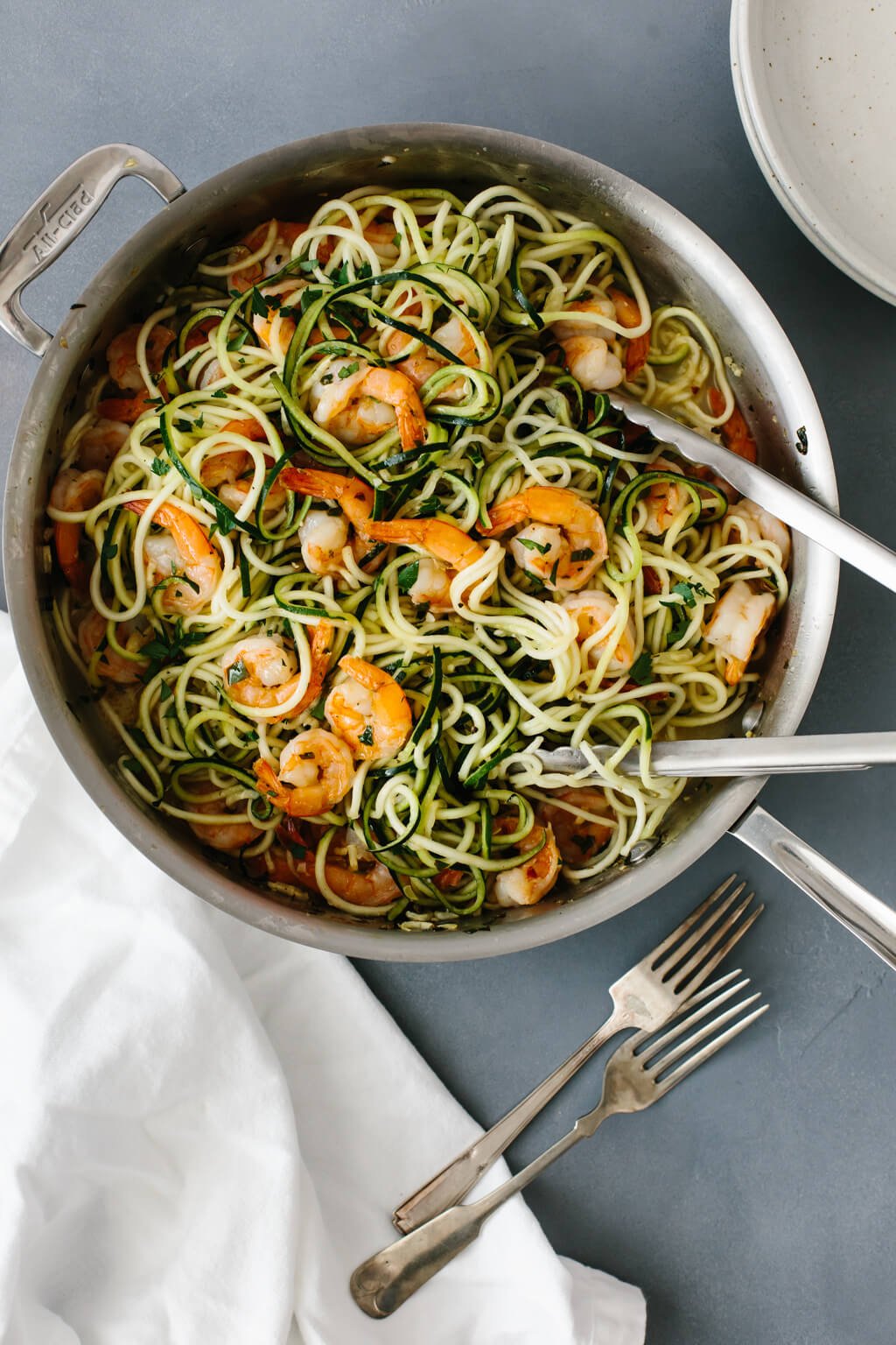 This zucchini pasta with lemon garlic shrimp is a delicious, gluten-free (and of course low-carb) version of shrimp scampi and linguini. Traditional pasta is replaced with zucchini noodles or zucchini pasta for a lighter, healthier meal. 