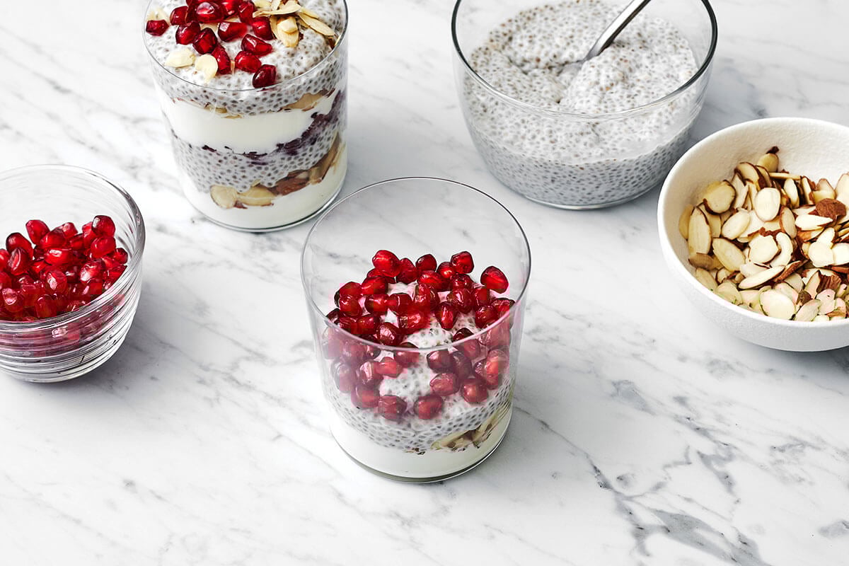 Assembling pomegranate chia pudding parfait