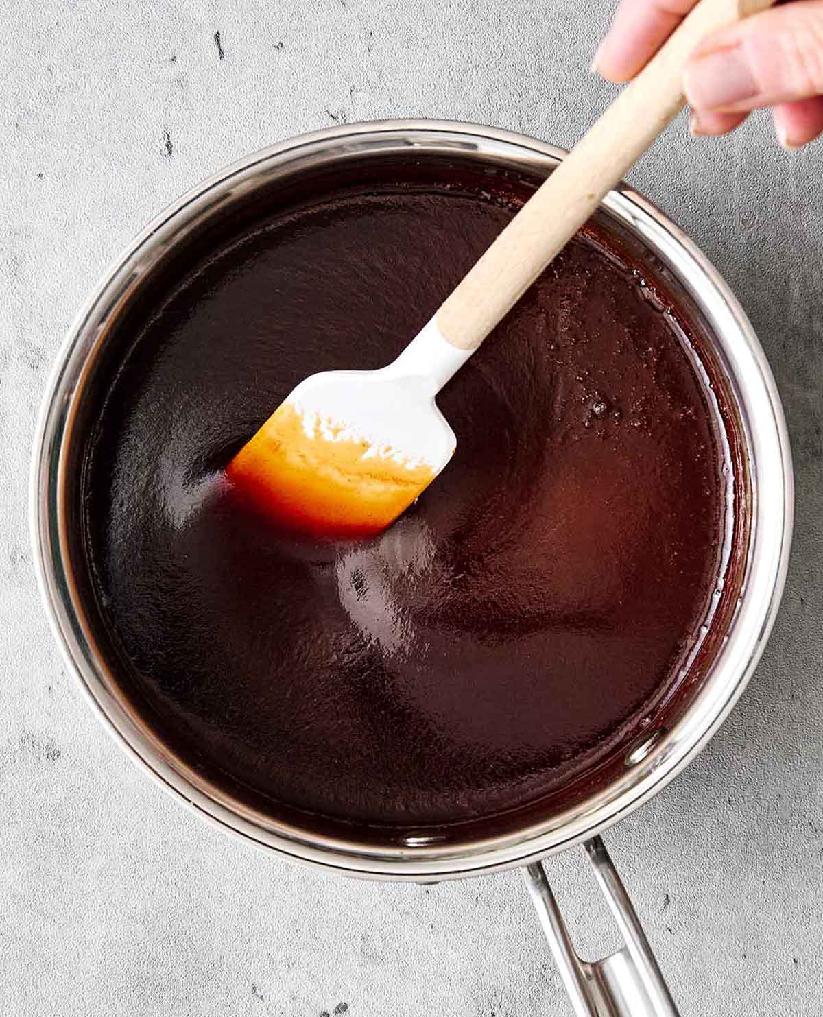 These baby back ribs are my secret to the best cookout meal. Guaranteed to be fall-apart tender with the best pineapple BBQ sauce! Making spiced rum pineapple BBQ sauce for ribs.