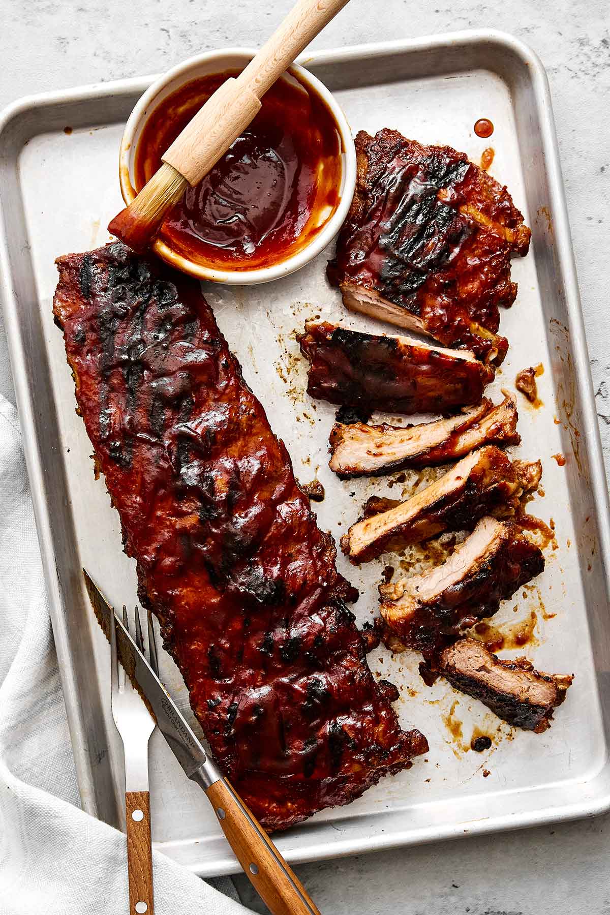 These baby back ribs are my secret to the best cookout meal. Guaranteed to be fall-apart tender with the best pineapple BBQ sauce! Baby back ribs with a spiced pineapple BBQ sauce.