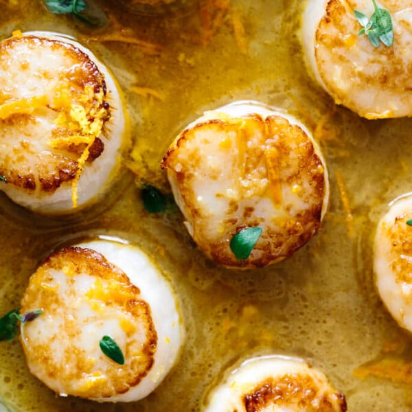 Close up of scallops in a pan.