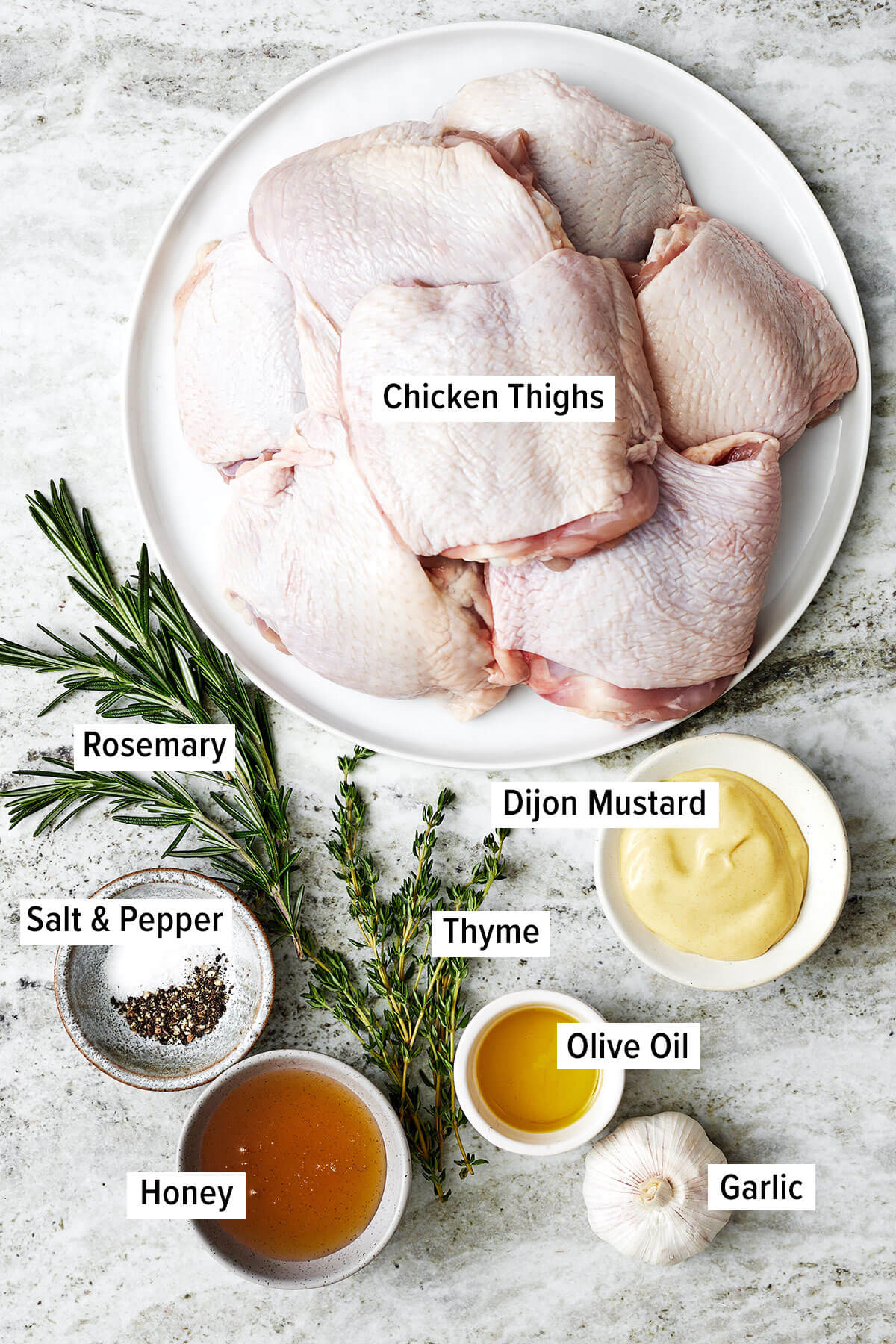 These honey mustard chicken thighs are just what you need to jazz up weeknight dinners! They're extra flavorful, juicy, and crisp. Ingredients for baked honey mustard chicken thighs on a table