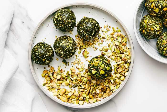 Rolling energy balls in pistachios.
