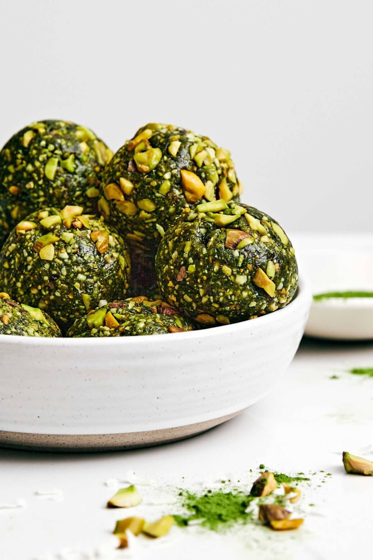 These matcha pistachio energy balls are my favorite power-packed healthy snack. Plus, they’re super easy to make and prep for the week! Matcha energy balls in a bowl.
