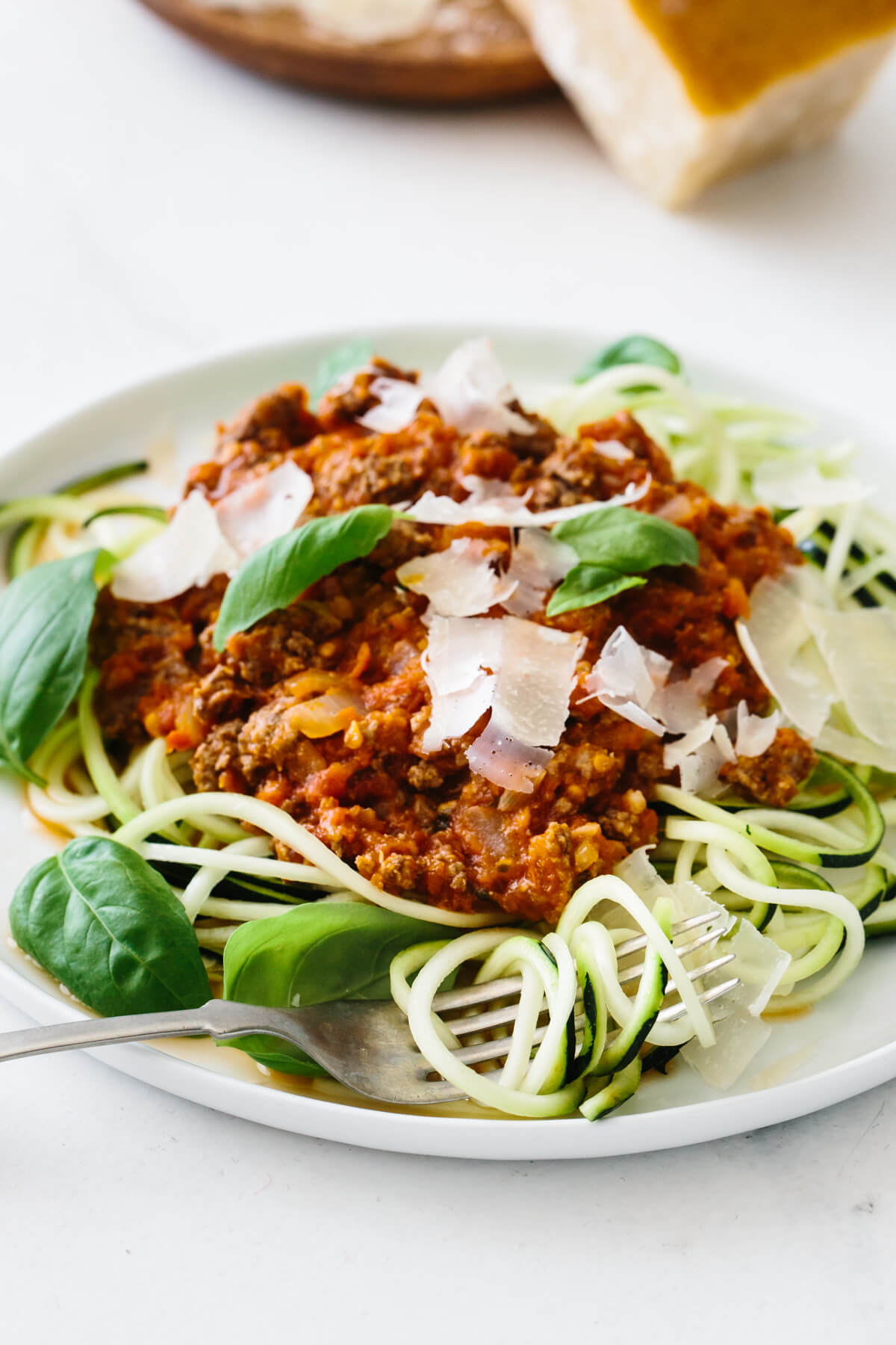 Close up photo of zucchini noodles with spaghetti bolognese sauce.
