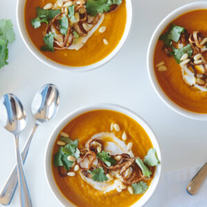 Carrot ginger soup with crispy shallots and coconut cream. A healthy soup that's gluten-free and dairy-free.