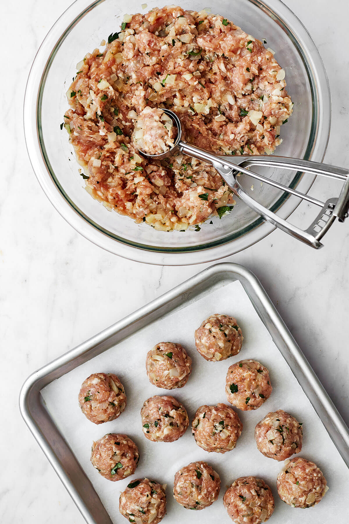 Raw pork meatballs on a sheet pan
