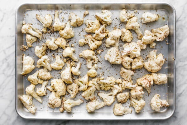 A sheet pan with roasted cauliflower on it