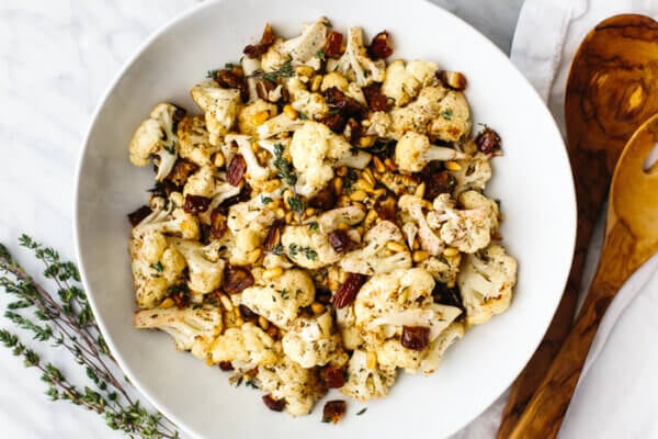 A big white bowl of roasted cauliflower
