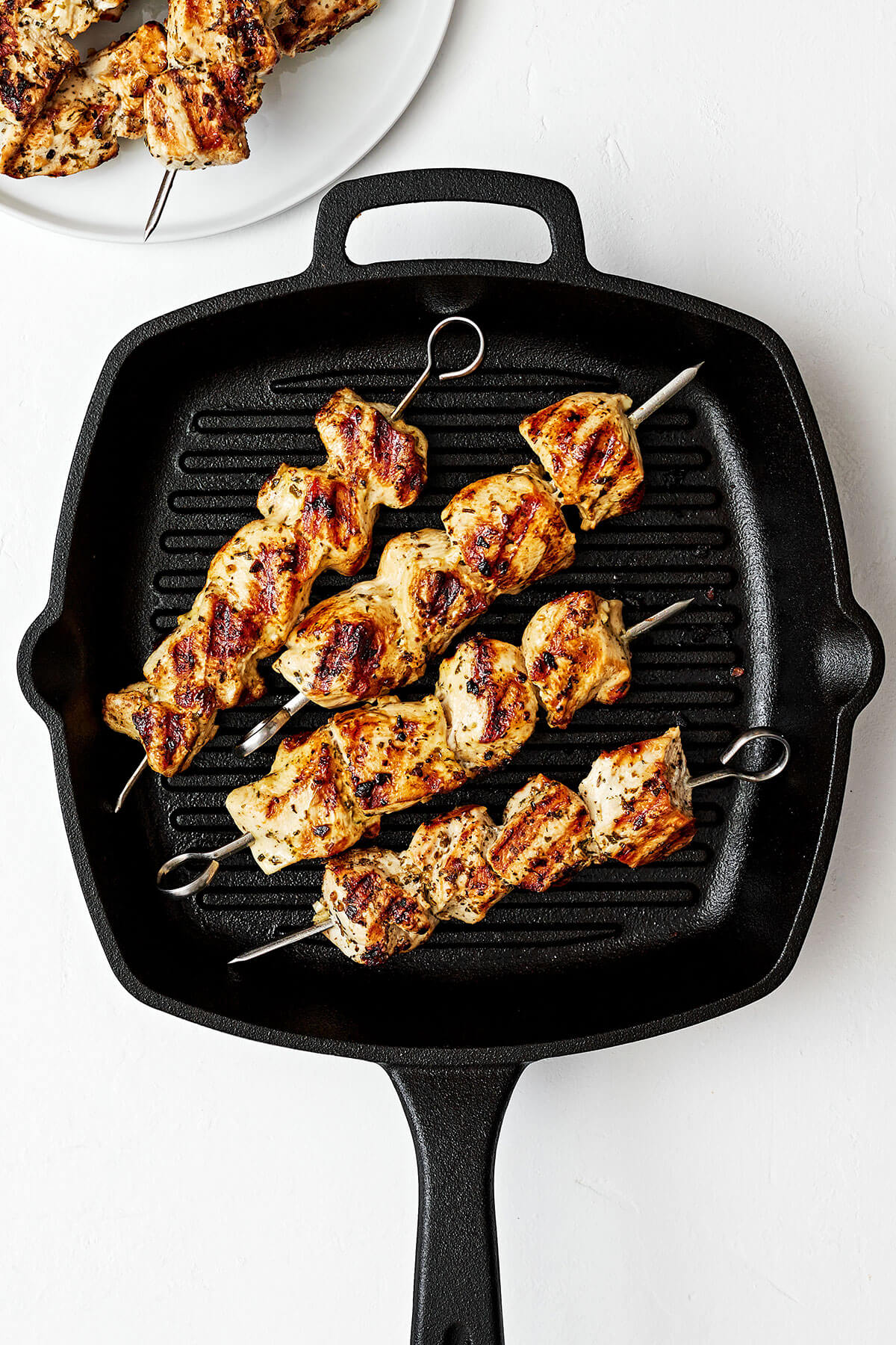 This Greek chicken souvlaki made with the best marinade will be everyone's favorite summer grilling recipe of the season! Grilling chicken souvlaki on a grill pan