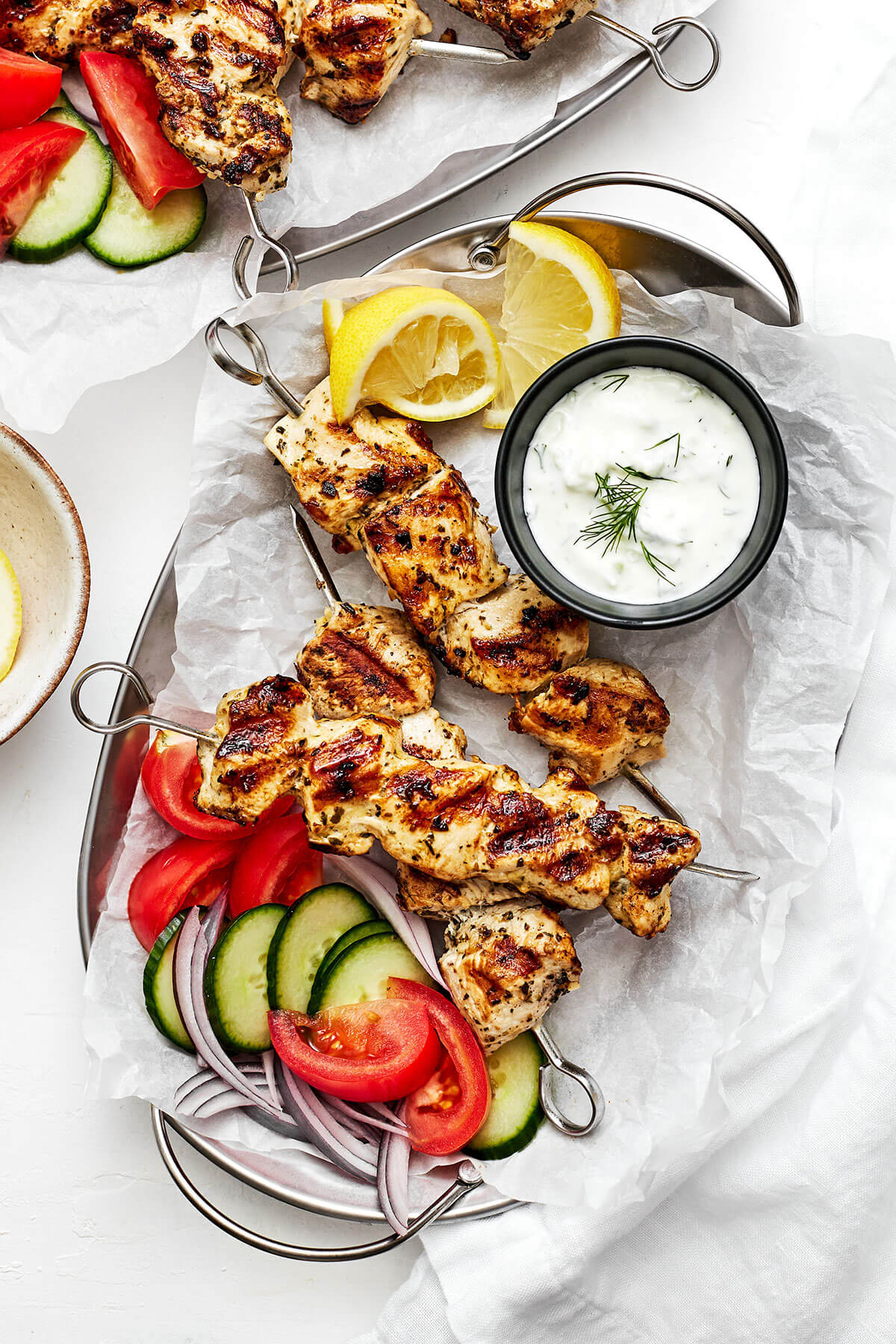 This Greek chicken souvlaki made with the best marinade will be everyone's favorite summer grilling recipe of the season! A plate of grilled chicken souvlaki
