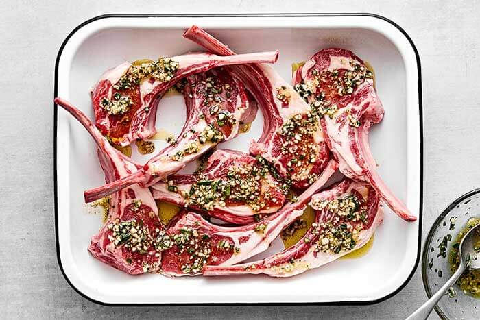 Marinated lamb chops in a baking tray.