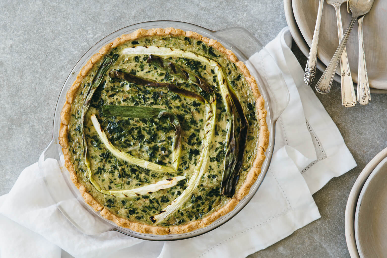 spinach artichoke quiche with grilled spring onions