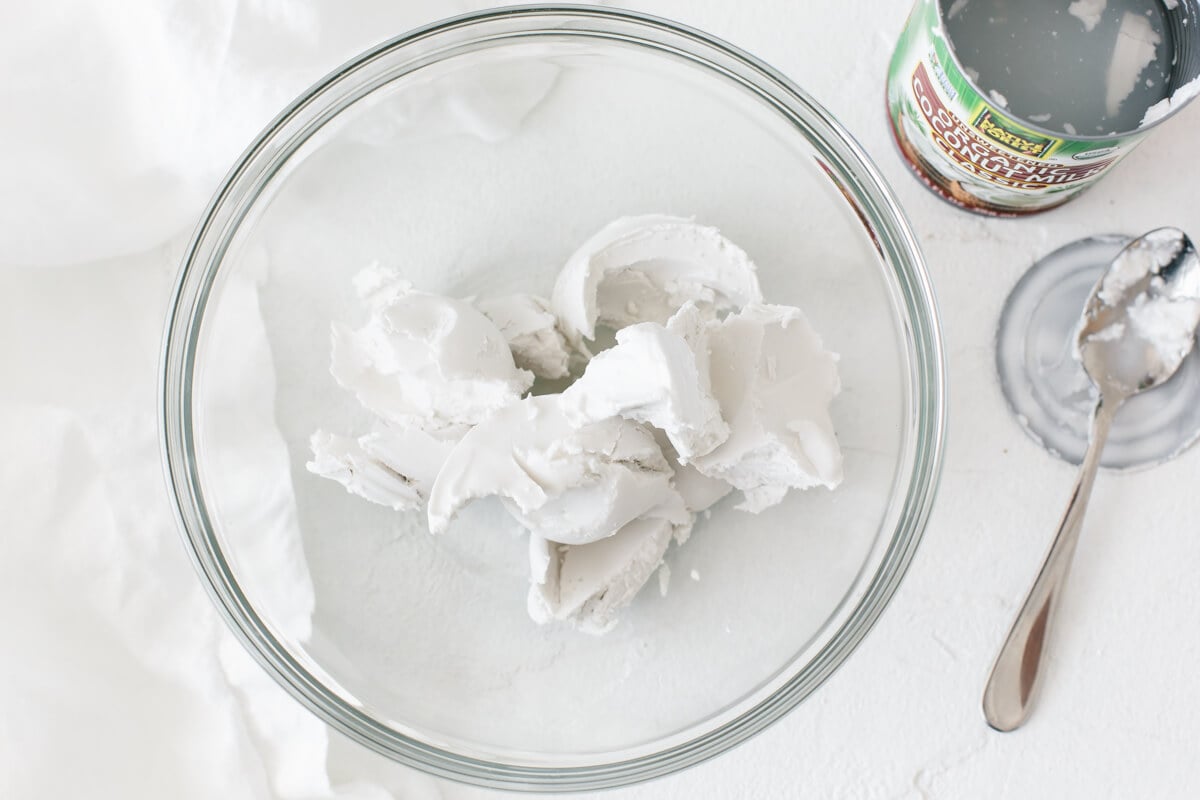 Hardened coconut cream scooped from the can into a bowl.