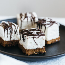 (gluten-free, paleo) Salted S'mores Bites. A graham cracker crust is topped with fluffy marshmallow, drizzled with chocolate and sprinkled with sea salt.