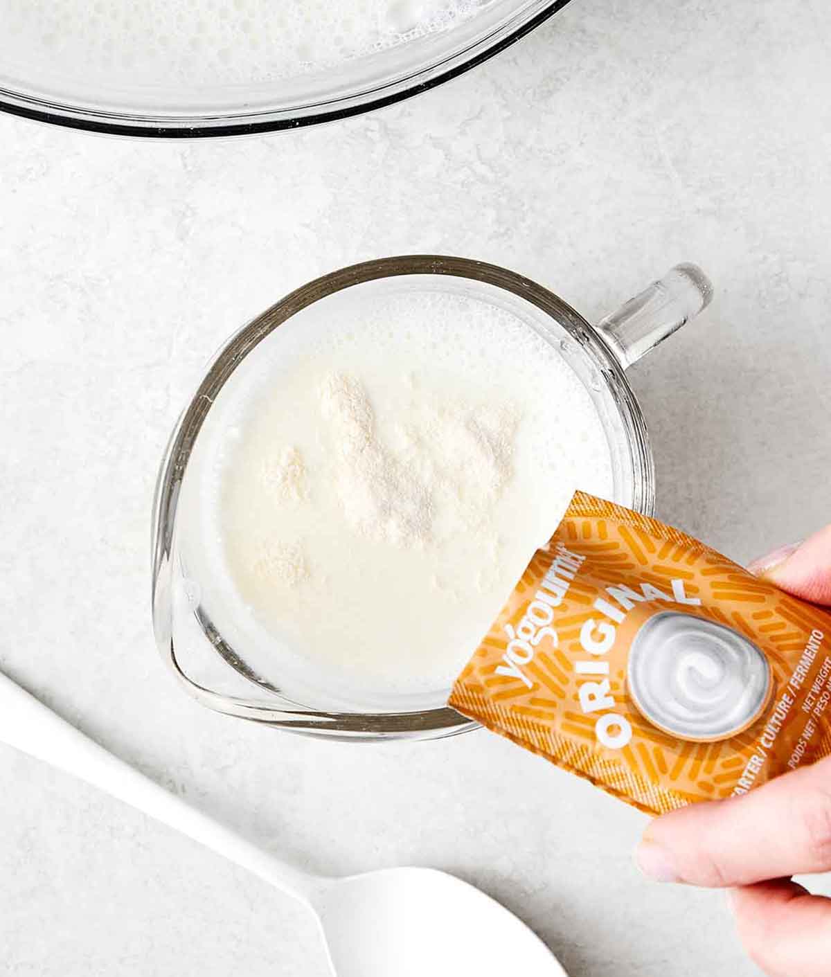 Step two of homemade yogurt: Add the yogurt starter.