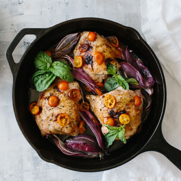 This one pan, roasted basil chicken is an easy meal that's bursting with flavor. Red onions and sliced kumquats become deliciously sweet when roasted.