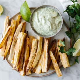 Baked yuca fries (also known as cassava fries) are golden and crispy on the outside and soft on the inside. They're a healthier way to make yuca fries and I'm serving them up with cilantro lime mayonnaise.
