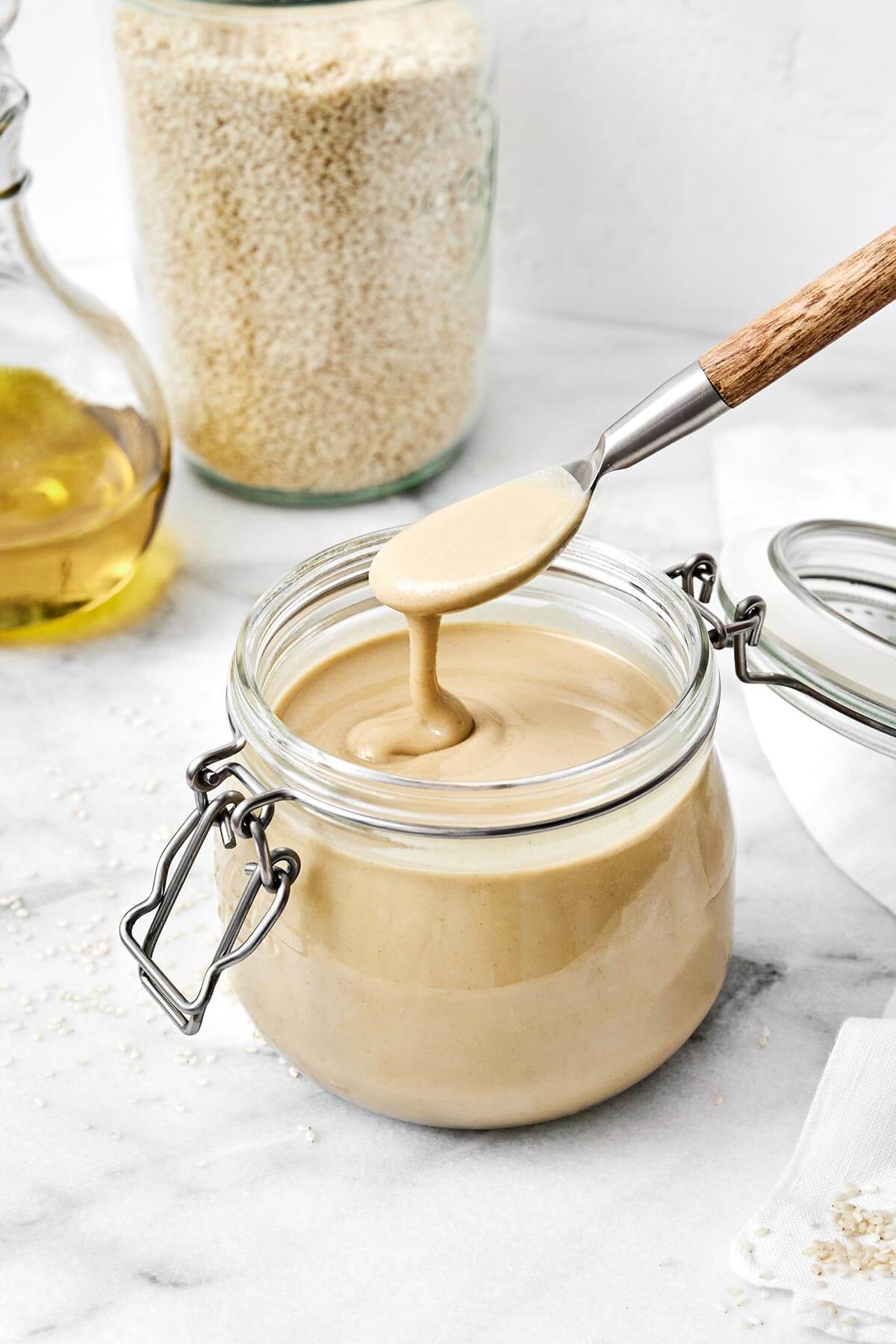It’s super easy to make homemade tahini in a blender! All you need are sesame seeds and olive oil for a fresh, creamy, and smooth texture. Tahini in a jar.