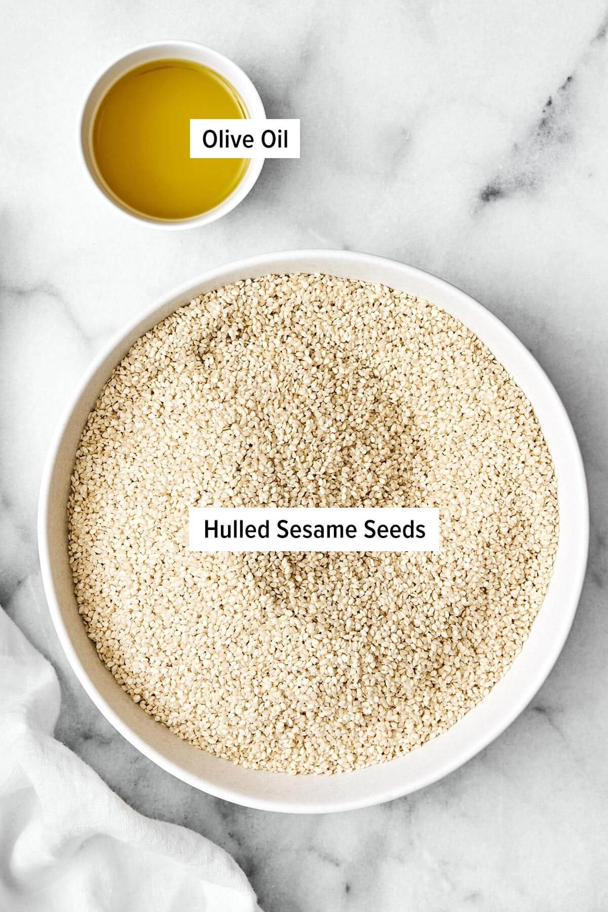 It’s super easy to make homemade tahini in a blender! All you need are sesame seeds and olive oil for a fresh, creamy, and smooth texture. Ingredients for homemade tahini.