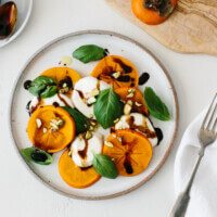 Persimmon Caprese is the perfect fall and winter appetizer or healthy salad. It's bright, flavorful, beautiful and easy to make!