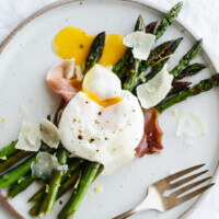 Breakfast doesn't get much better than garlic sautéed asparagus topped with prosciutto, a perfectly poached egg and a few shavings of parmesan.