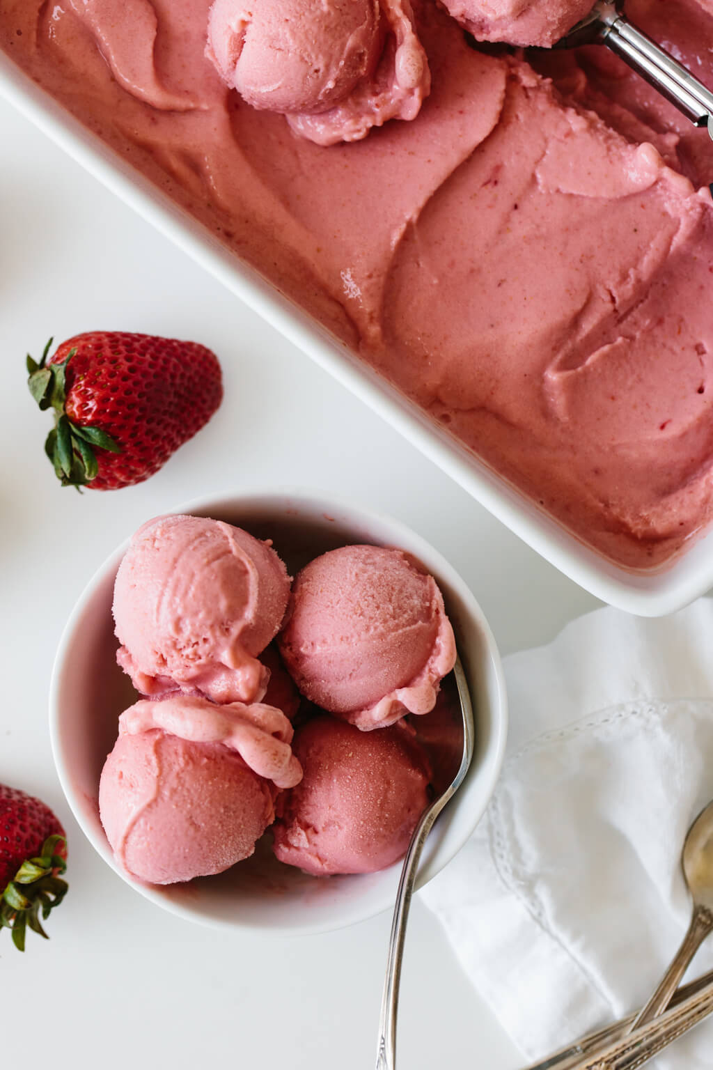This strawberry frozen yogurt recipe is beyond easy. It takes just three ingredients and 30 seconds! Strawberry frozen yogurt scooped into a bowl.