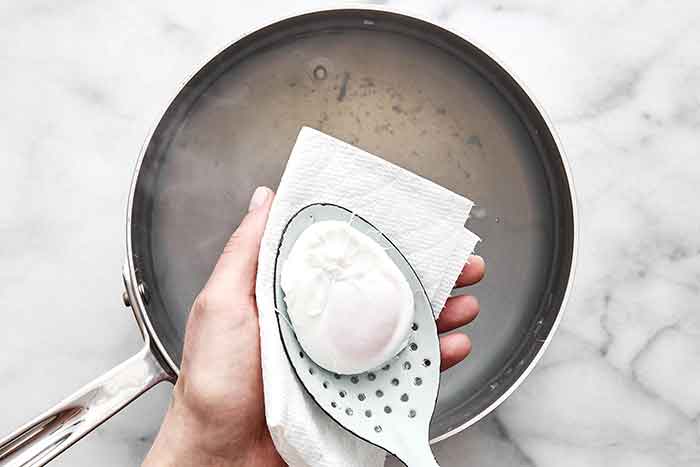 Step four of poached eggs: Remove the egg.