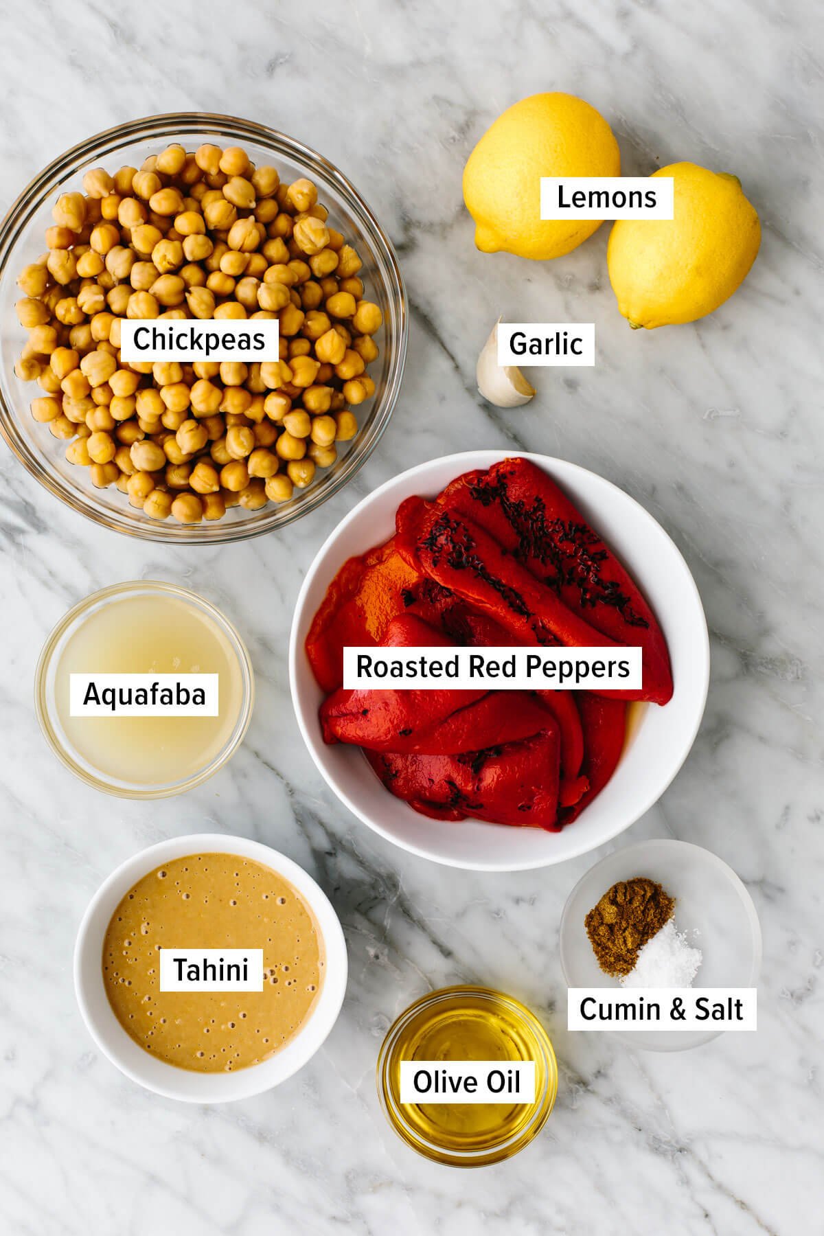 Ingredients for roasted red pepper hummus on a table.