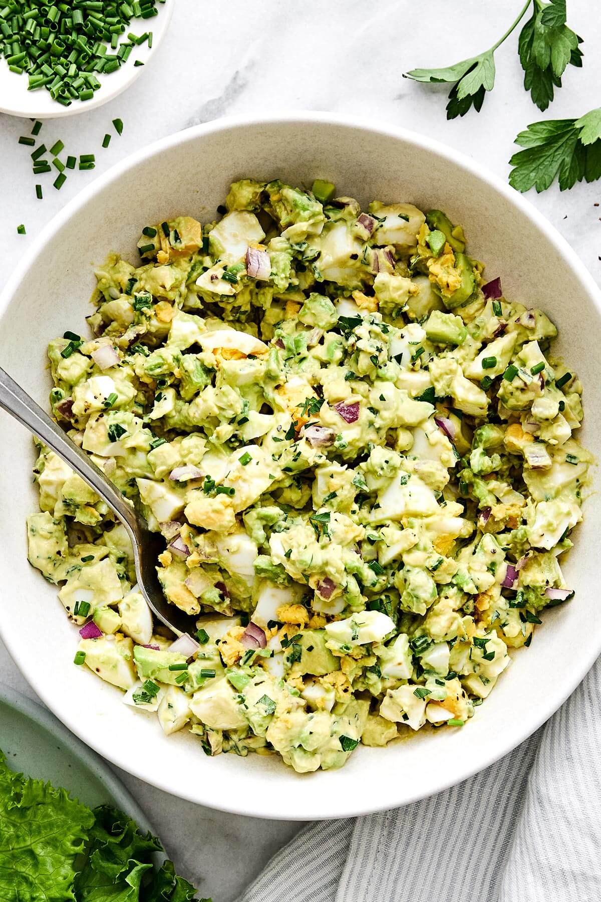 This avocado egg salad is a healthy twist on your classic egg salad with creamy avocado and fresh herbs—a salad recipe you'll love! A bowl of avocado egg salad.