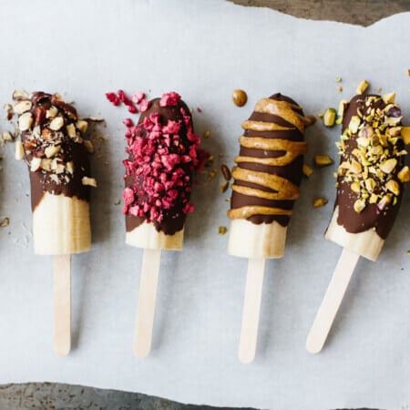 Chocolate covered bananas are frozen bananas dipped in melted chocolate and sprinkled with a variety of toppings including nuts, dried fruit and shredded coconut.