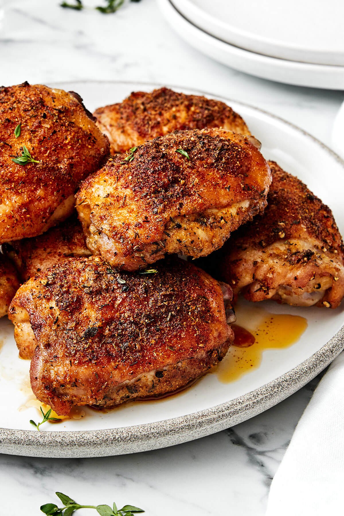 These crispy and juicy baked chicken thighs make for the perfect weeknight meal. They’re incredibly easy to make and packed with flavor! Crispy baked chicken thighs on a plate.
