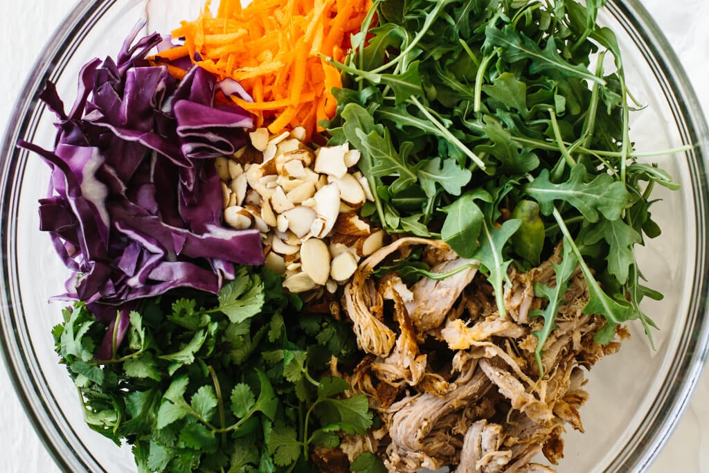 Pulled pork, cabbage and arugula salad with citrus lime vinaigrette. A hearty, flavorful and healthy salad recipe.