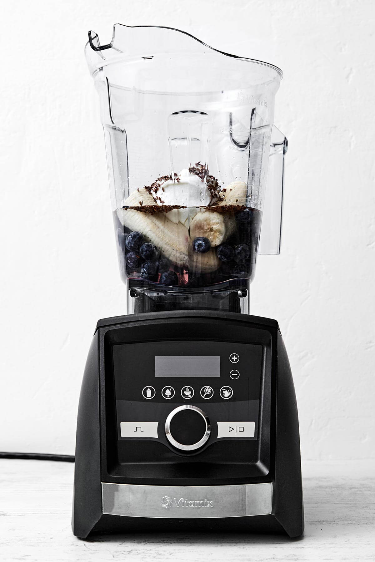 Blueberry smoothie ingredients in a blender.