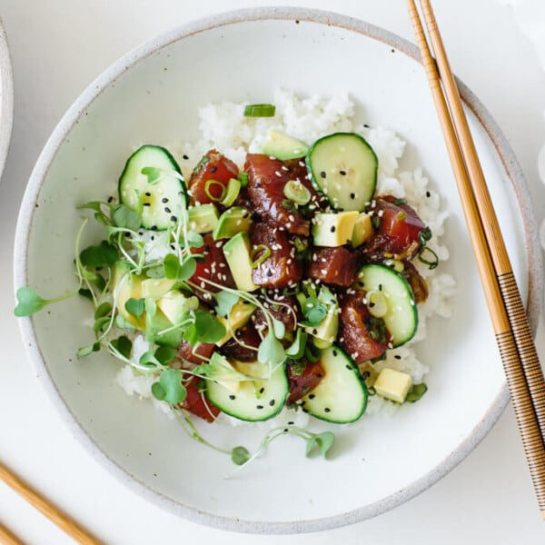 Poke bowl is easy to make at home. This ahi poke bowl recipe is made with ahi tuna, a soy sauce marinade and sushi rice, then topped with cucumber, avocado, microgreens and sprinkled with sesame seeds. It's a healthy, gluten-free poke bowl recipe.