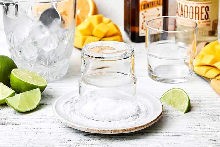 Adding salt rim to a glass.