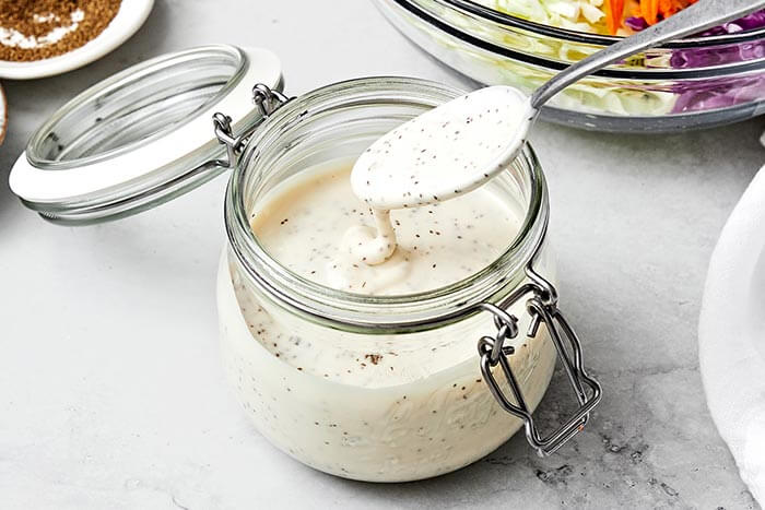A spoon with coleslaw dressing.