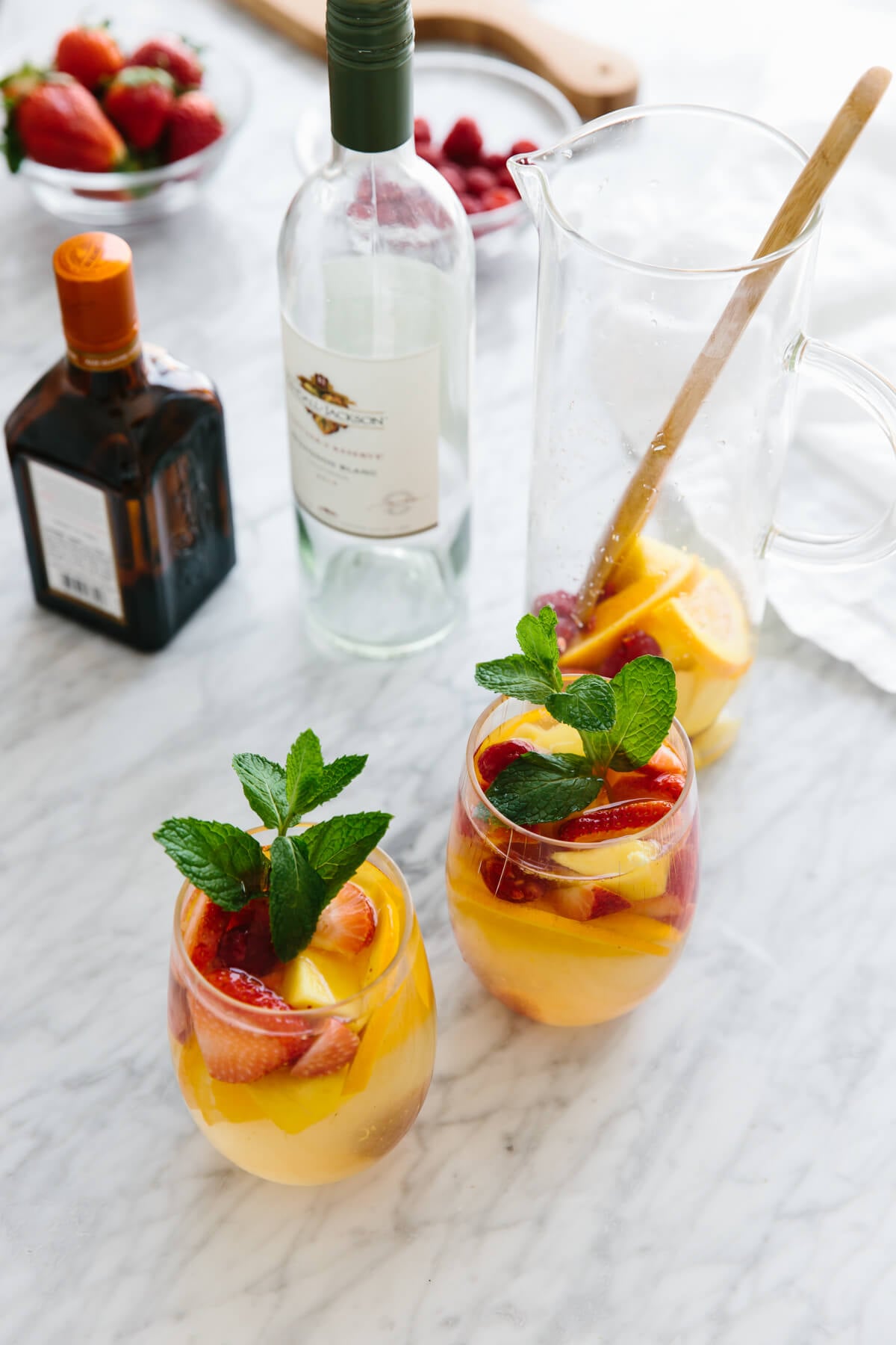 This white sangria with mango and berries is the perfect fruity, summer cocktail. Glasses of white sangria