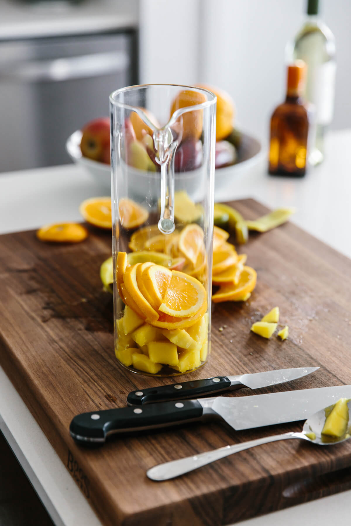 This white sangria with mango and berries is the perfect fruity, summer cocktail. Slicing up fruit to add into a pitcher