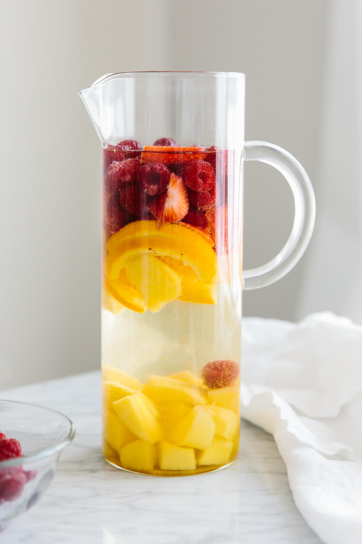 This white sangria with mango and berries is the perfect fruity, summer cocktail. A pitcher of white sangria