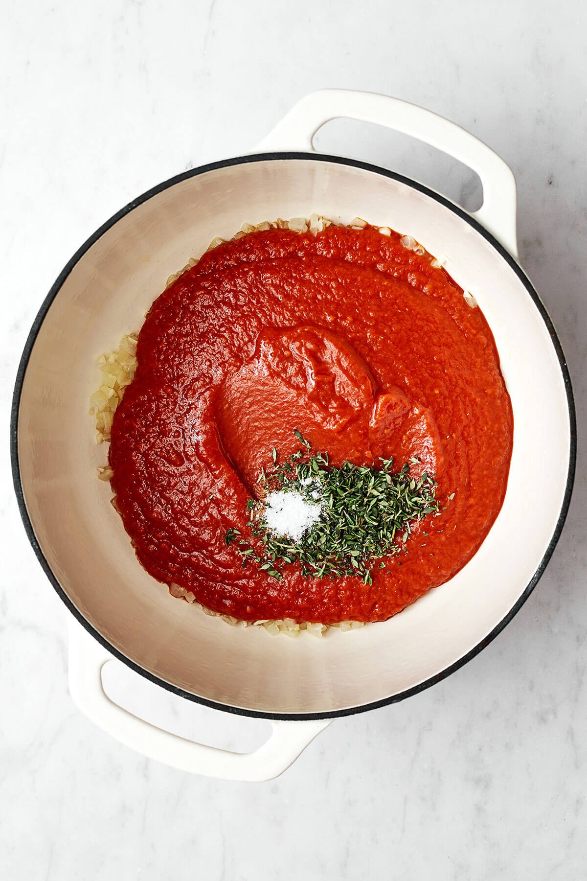 Nothing outshines a fresh batch of this homemade marinara sauce. Bonus — it’s super easy to make with just 5 simple ingredients! Marinara sauce ingredients in a pot