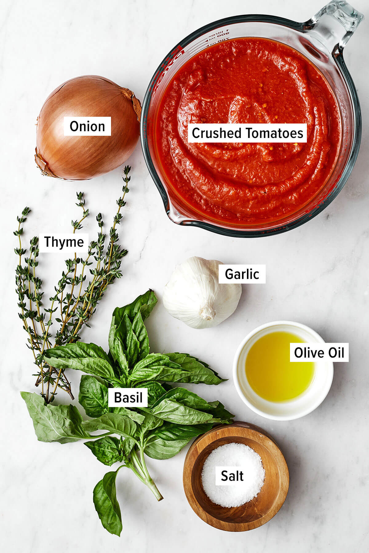 Nothing outshines a fresh batch of this homemade marinara sauce. Bonus — it’s super easy to make with just 5 simple ingredients! Ingredients for marinara sauce on a table
