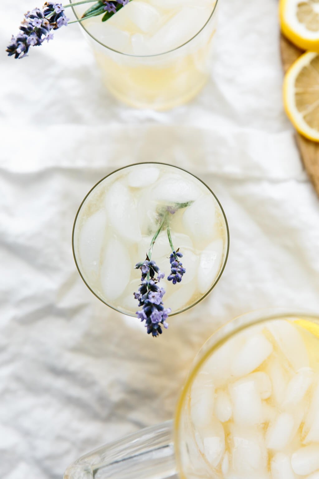 Top down view of lemonade in a glass with ice and a sprig of fresh lavender.