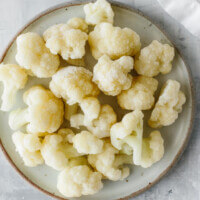 Frozen cauliflower florets on a plate.