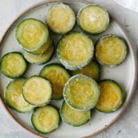 Frozen zucchini slices on a plate.