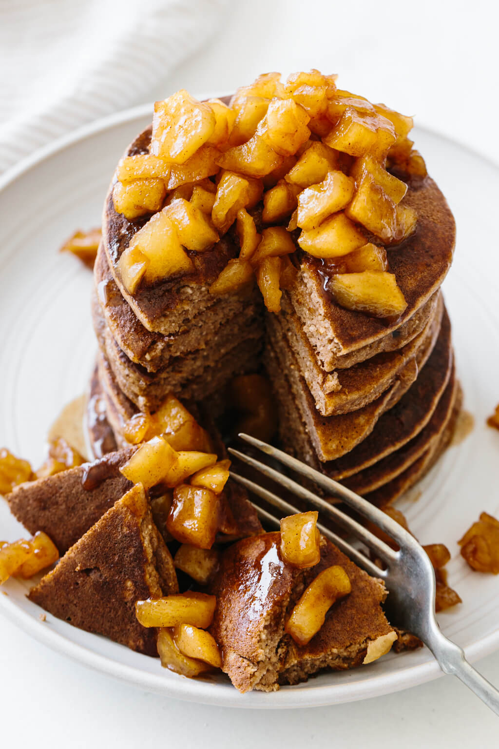 Stack of apple pancakes cut into.