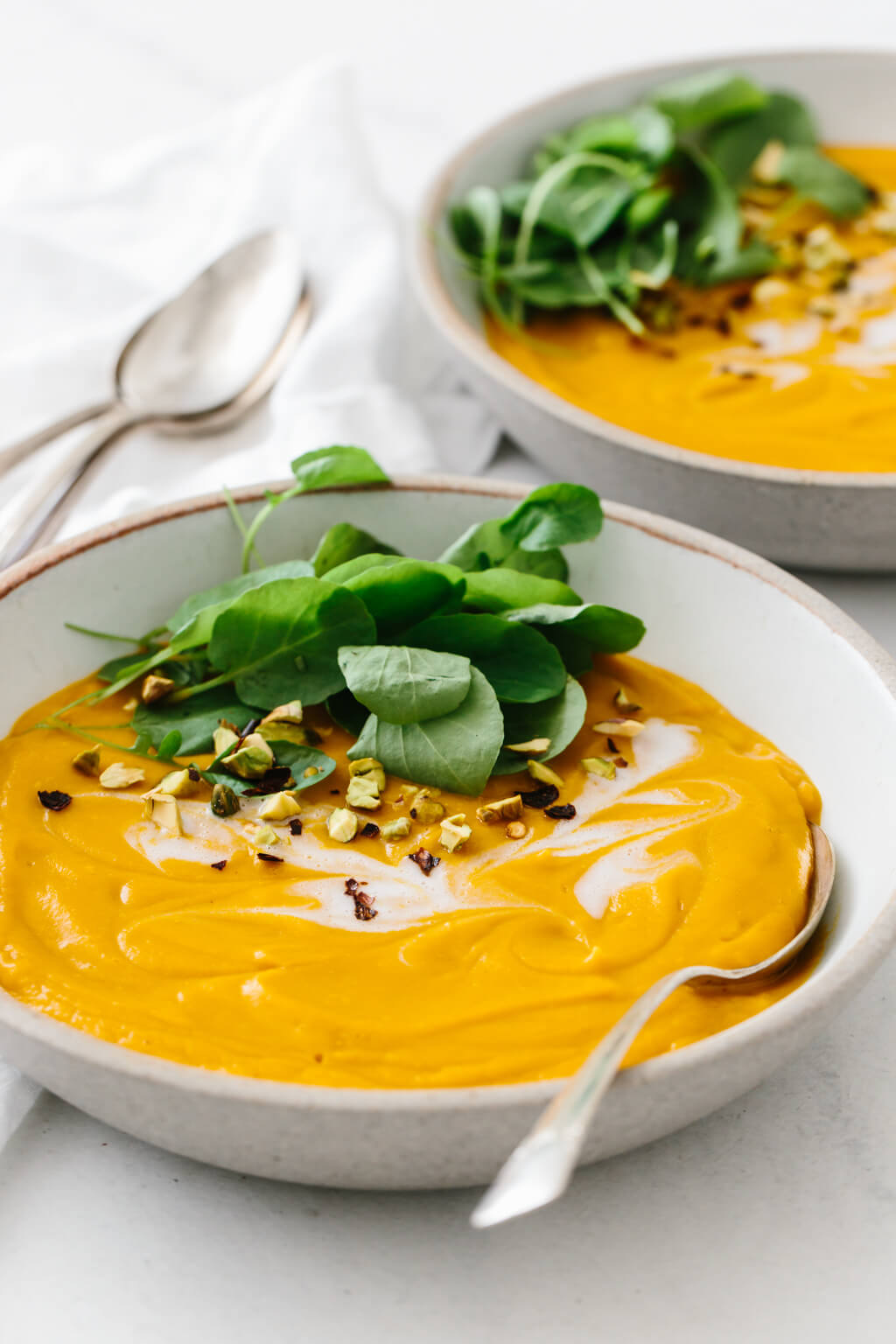 Two bowls of sweet potato soup. 
