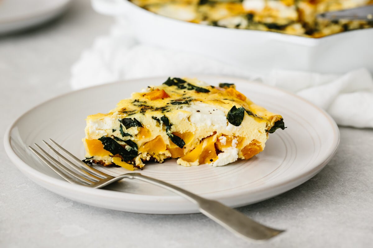 A single slice of butternut squash frittata on a plate.