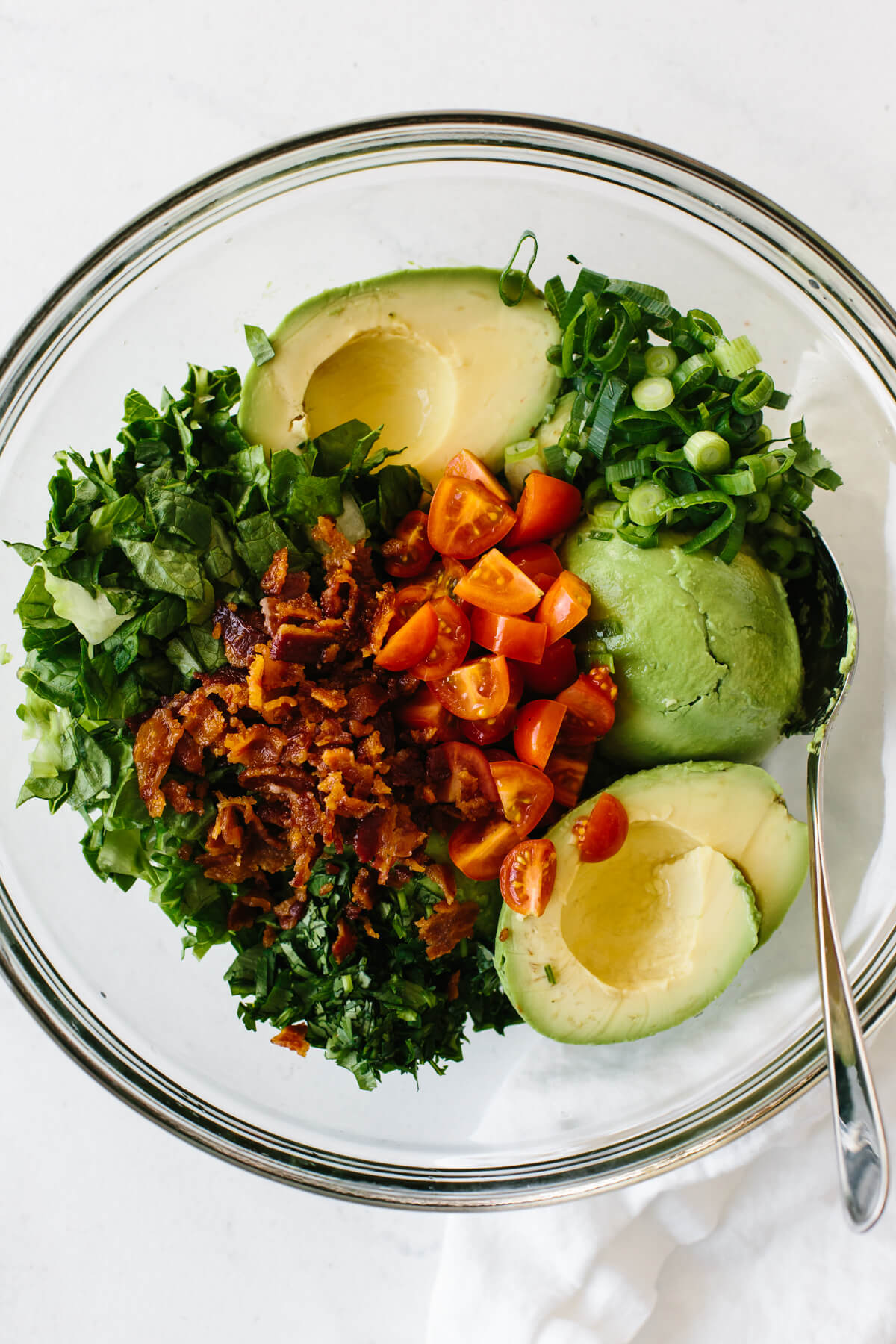 BLT guacamole ingredients in a mixing bowl.