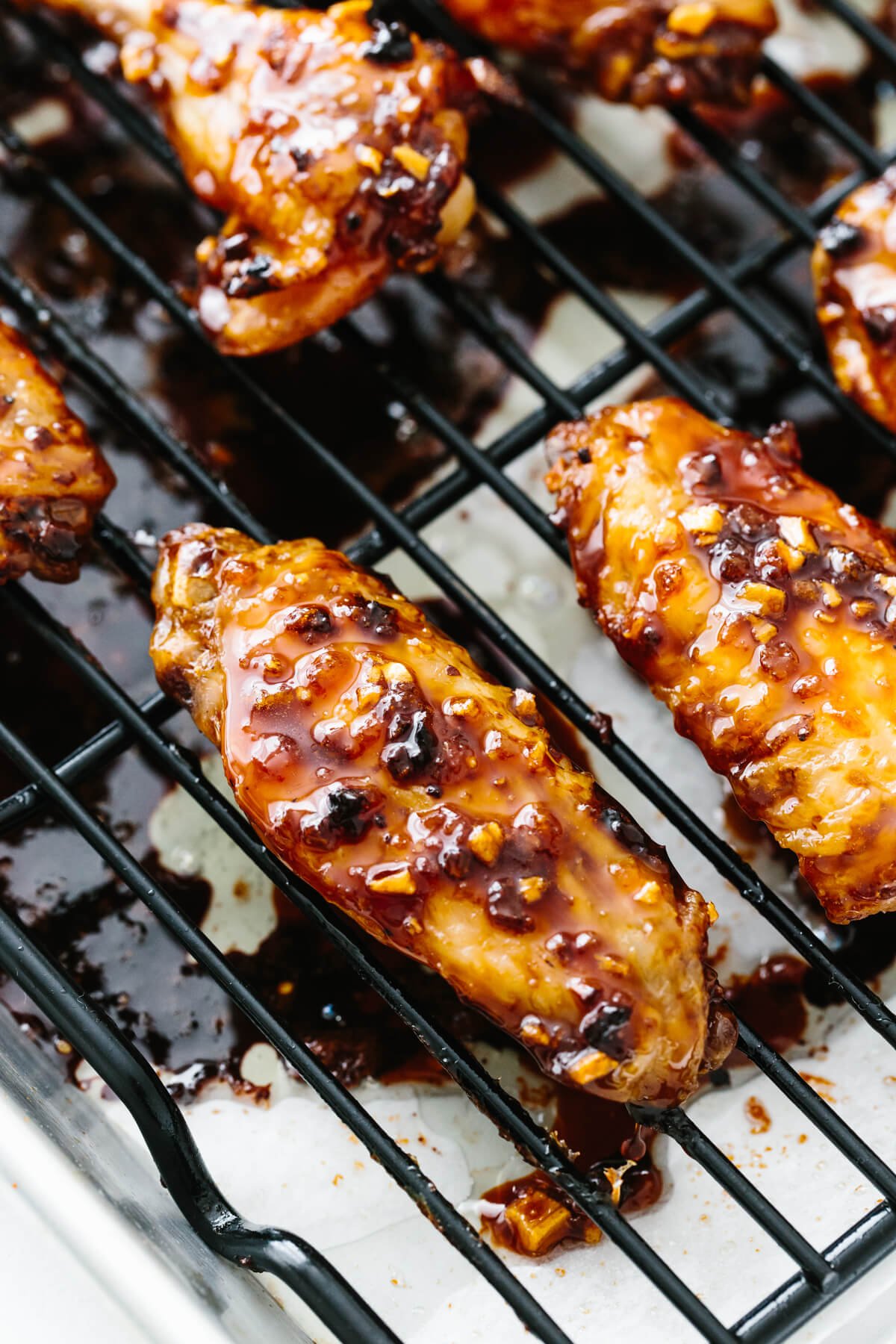 Soy garlic ginger chicken wings are a sticky, sweet and flavorful appetizer with a kick! The perfect party or Super Bowl recipe! A chicken wing coated in soy ginger garlic sauce.